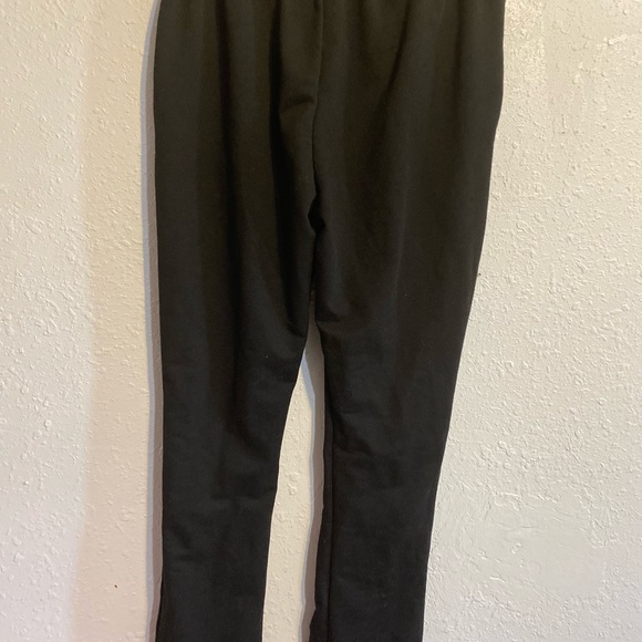 Black pants with shooting star logo on front and bottom flare legs - Picture 3 of 3